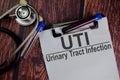 UTI - Urinary Tract Infection text write on a paperwork isolated on office desk. Healthcare/Medical concept