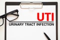 UTI- Urinary Tract Infection written in notebook