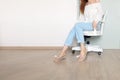 Utiful male Wearing White Shirt and Blue Jeans Isolated. Stylish Pink Sandal Shoes. Portrait of Woman Sitting on White Chair Iso