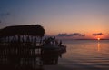 Utila, Honduras: People watching the sunset on the wooden pier