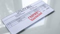 Utility bill past due, seal stamped on document, payment for services, tariff