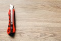 Utility knife on wooden table, top view. Space for text Royalty Free Stock Photo