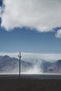 Utility pole and steam rising in front of mountains Royalty Free Stock Photo