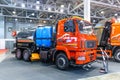Utility vehicle for cleaning streets based on the MAZ truck. MAZ trucks stand at the construction industry exhibition