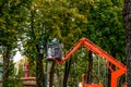 A utility worker on an aerial platform repairs a street lamp in the Park Royalty Free Stock Photo