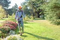 Utility worker with brush cutting for remove grass