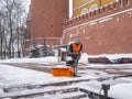 A utility worker cleans snow with a snowplow at the grave of the Unknown Soldier in the Kremlin during a snowfall Royalty Free Stock Photo