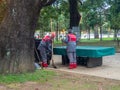 Utility workers. Cleaners at work. Street cleaning workers. Modern working professions. On the street