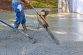 Utilizing tamping machine to align compacted concrete on driveways Royalty Free Stock Photo