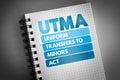 UTMA - Uniform Transfers to Minors Act acronym on notepad, law concept background