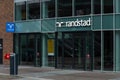 Randstad Uitzendbureau Sign on reflecting windows above the entrance.