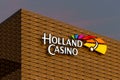 Holland Casino illuminated logo on illuminated building.