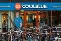 Coolblue store front with logo signage, bikes in front of the shop.