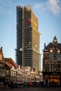 Cityscape view with incidental people of the famous Dom Tower of Utrecht undergoing renovation in Utrecht. Royalty Free Stock Photo