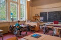 Utrecht, Netherlands - october 12 2021: A student sits in an otherwise empty classroom in a primary school. The coats and bags of