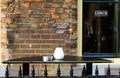 UTRECHT, NETHERLANDS - OCTOBER 20. 2018: View on isolated empty black table with ashtray outside restaurant with window and brick Royalty Free Stock Photo