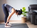 Uttanasana Standing Forward Bend yoga pose asian woman home workout fitness body exercise health training sport healthy lifestyle Royalty Free Stock Photo