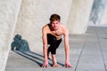 Utthita Ashwa Sanchalanasana, runner`s posture in yoga, is useful for many sports, young man practices it outdoors Royalty Free Stock Photo