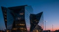 uturistic building with a striking, angular design, located in an urban setting against a
