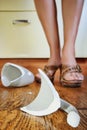 Uups! Broken cup near female leg Royalty Free Stock Photo