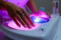uv lamp curing gel on hands in a nail salon