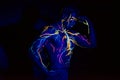 UV patterns body art of the circulatory system on a man`s body. On the chest of a muscular athlete, veins and arteries are drawn