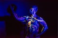 UV patterns body art of the circulatory system on a man`s body. On the chest of a muscular athlete, veins and arteries