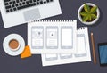 UX designer desk with mobile app wireframes