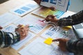 UX developer and ui designer brainstorming about mobile app interface wireframe design with customer breif and color code at Royalty Free Stock Photo