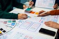 UX developer and ui designer brainstorming about mobile app interface wireframe design with customer breif and color code, User Royalty Free Stock Photo