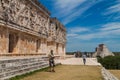 UXMAL, MEXICO - FEB 28, 2016: Tourists visit the ruins of the Palacio del Gobernador Governor`s Palace building in the