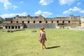 Uxmal, Mexico, 2015-04-20: Old stylish lady standing at the sight of Mayan ancient pyramids