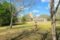 Uxmal, Mexico, 2015-04-20: Old stylish lady standing at the sight of Mayan ancient pyramids