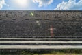 Uxmal, Mexico, 2015-04-20: Old stylish lady standing at the stairs of Mayan ancient pyramids