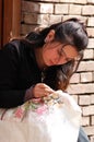 Uyghur girl embroidering Royalty Free Stock Photo