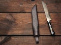Uyghur Uzbek traditional universal sharp knife with a black handle on a brown wooden background Royalty Free Stock Photo