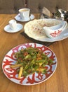 Uzbek food beef salad and kutab in a restaurant.