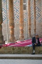 Uzbek man sitting in the courtyard of a mosque in Shahrisabz, Uzbekistan