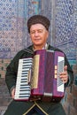 Uzbek musician with an accordian in Khiva