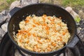 Uzbek national dish pilaf rice in a cast iron cauldron