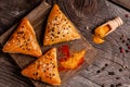 Uzbek national dish samosa. Wooden board with delicious samosas on table. Samosa, samsa meat stuffed pies, oriental style Royalty Free Stock Photo