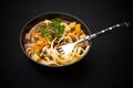 Uzbek noodle soup Lagman on black Royalty Free Stock Photo