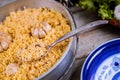 Uzbek pilaf, rice with garlic in iron pot and plate Royalty Free Stock Photo