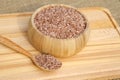 Uzbek rice for pilaf - devzira in a bamboo bowl on a wooden Board