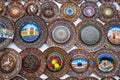 Uzbek wooden handmade gift plates with wood carvings hand-painted in souvenir shop of Uzbekistan in Tashkent