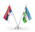 Uzbekistan and Serbia table flags isolated on white 3D rendering