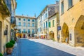 UZES, FRANCE, JUNE 20, 2017: People are strolling through a narrow street in the center of Uzes, FranceUZES, FRANCE, JUNE 20, 2017