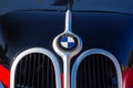 front close-up of a red bmw 321 oldtimer with black hood. sunny outdoor in autumn park