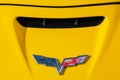 shabby chevrolet corvette logo on a yellow hood Royalty Free Stock Photo