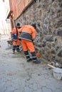 Uzhhorod, Ukraine - April 5, 2023: Workers repairing old stone wall outdoors in Uzhhorod